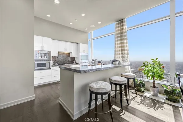 a view of a kitchen with utility area and windows