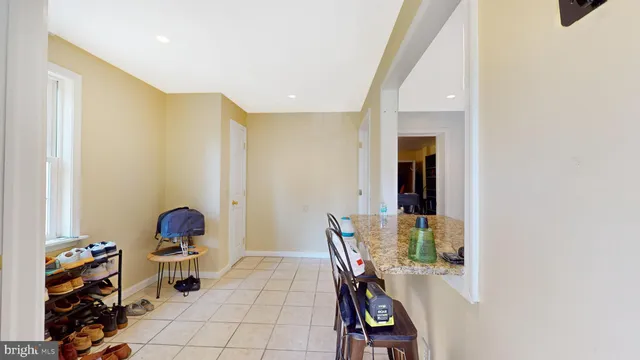 a view of a hallway with workspace and a couch