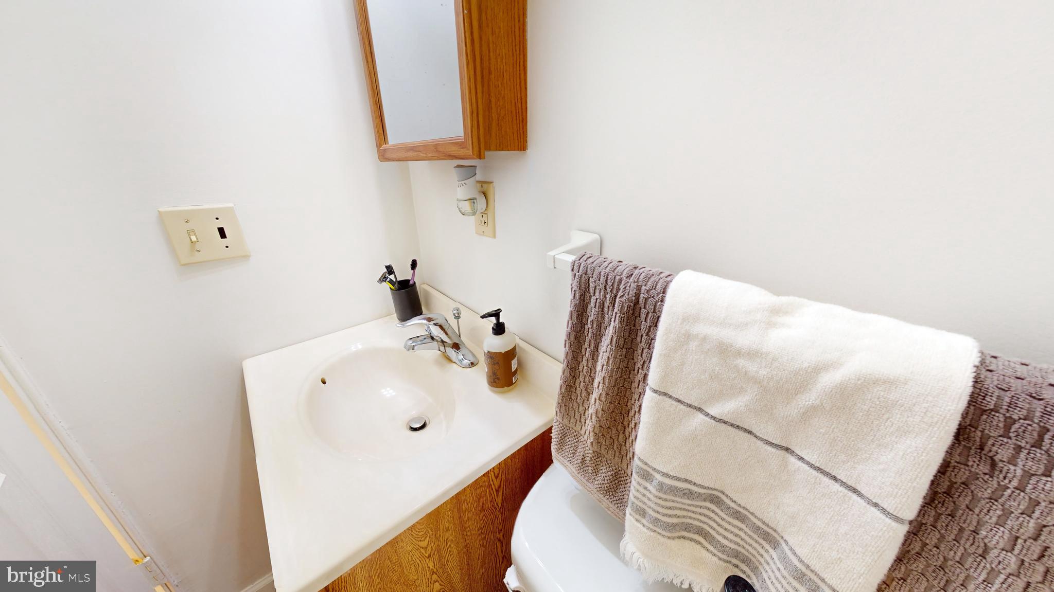 769 Ardmore Avenue Ardmore, PA 19003 - Photo 13 of 40 a bathroom with a sink and mirror