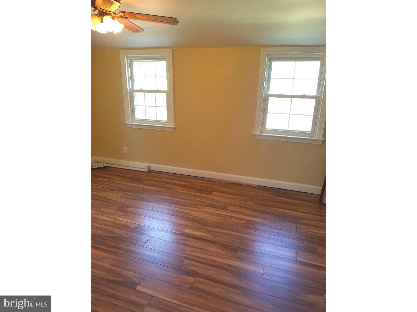 769 Ardmore Avenue Ardmore, PA 19003 - Photo 18 of 40 a view of an empty room with wooden floor and a window