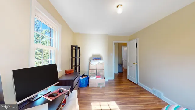 a living room with furniture chess board and a window