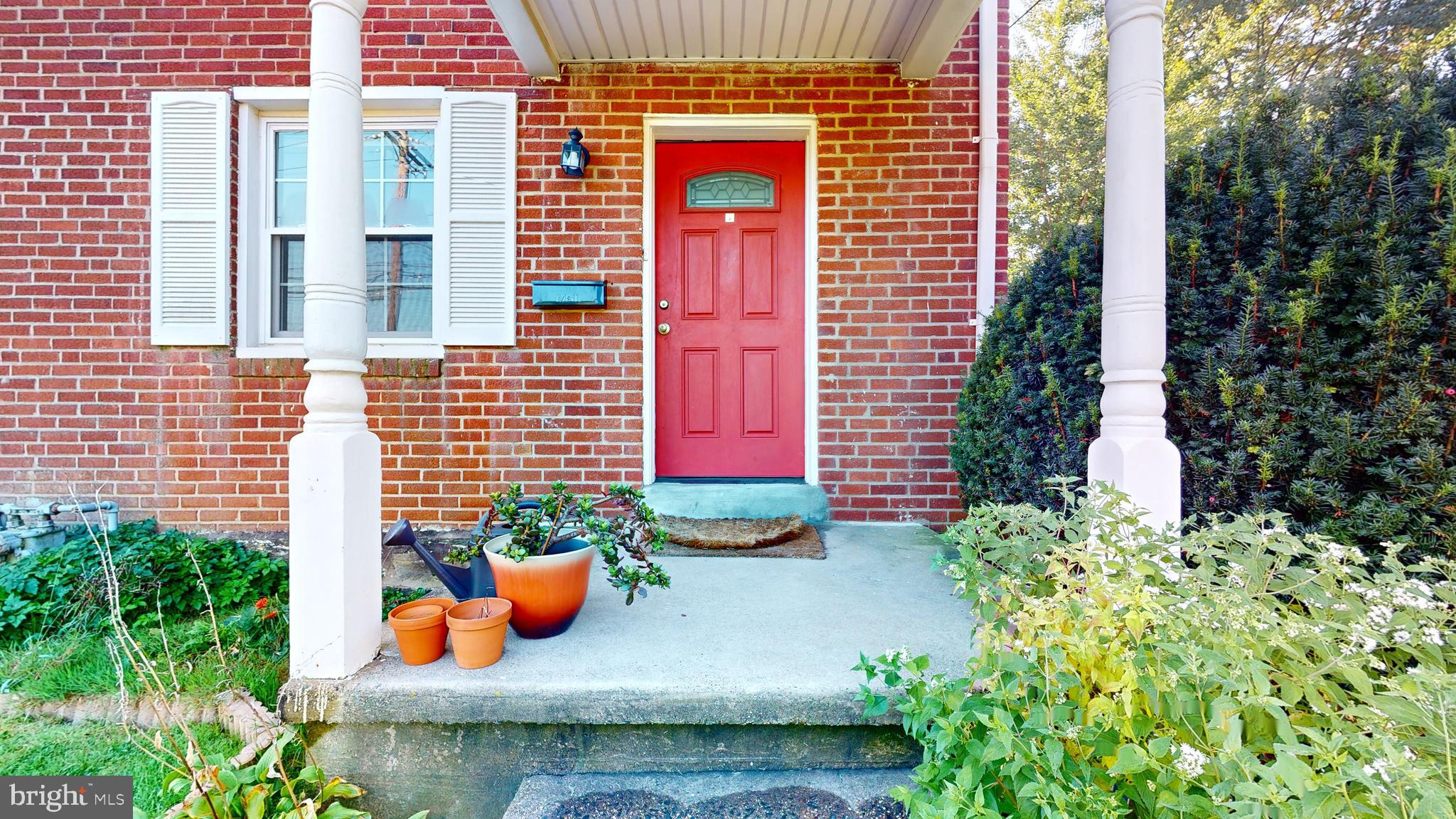 769 Ardmore Avenue Ardmore, PA 19003 - Photo 2 of 40 a view of a door of the house with chairs and potted plants