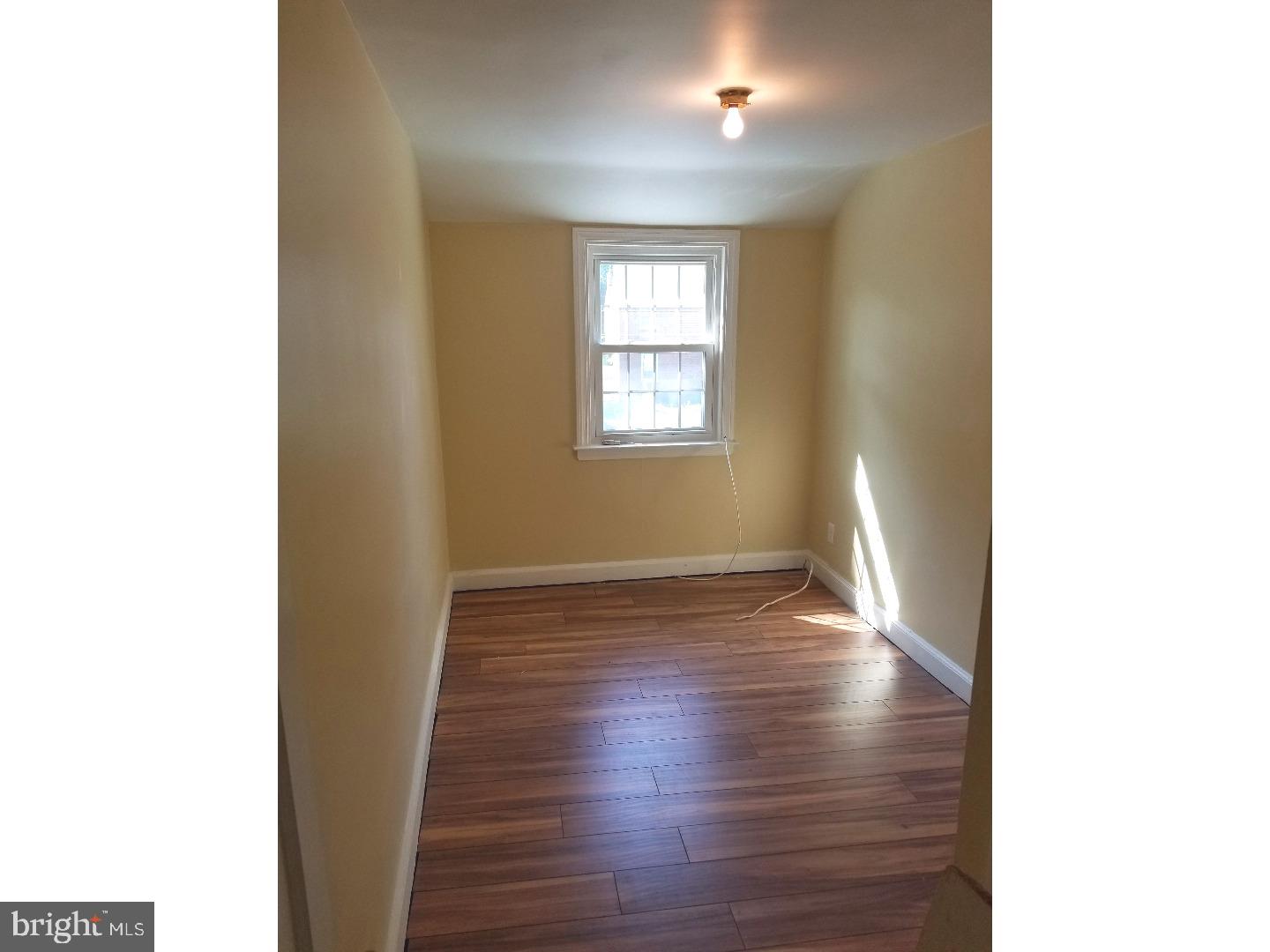 769 Ardmore Avenue Ardmore, PA 19003 - Photo 22 of 40 a view of an empty room with wooden floor and a window