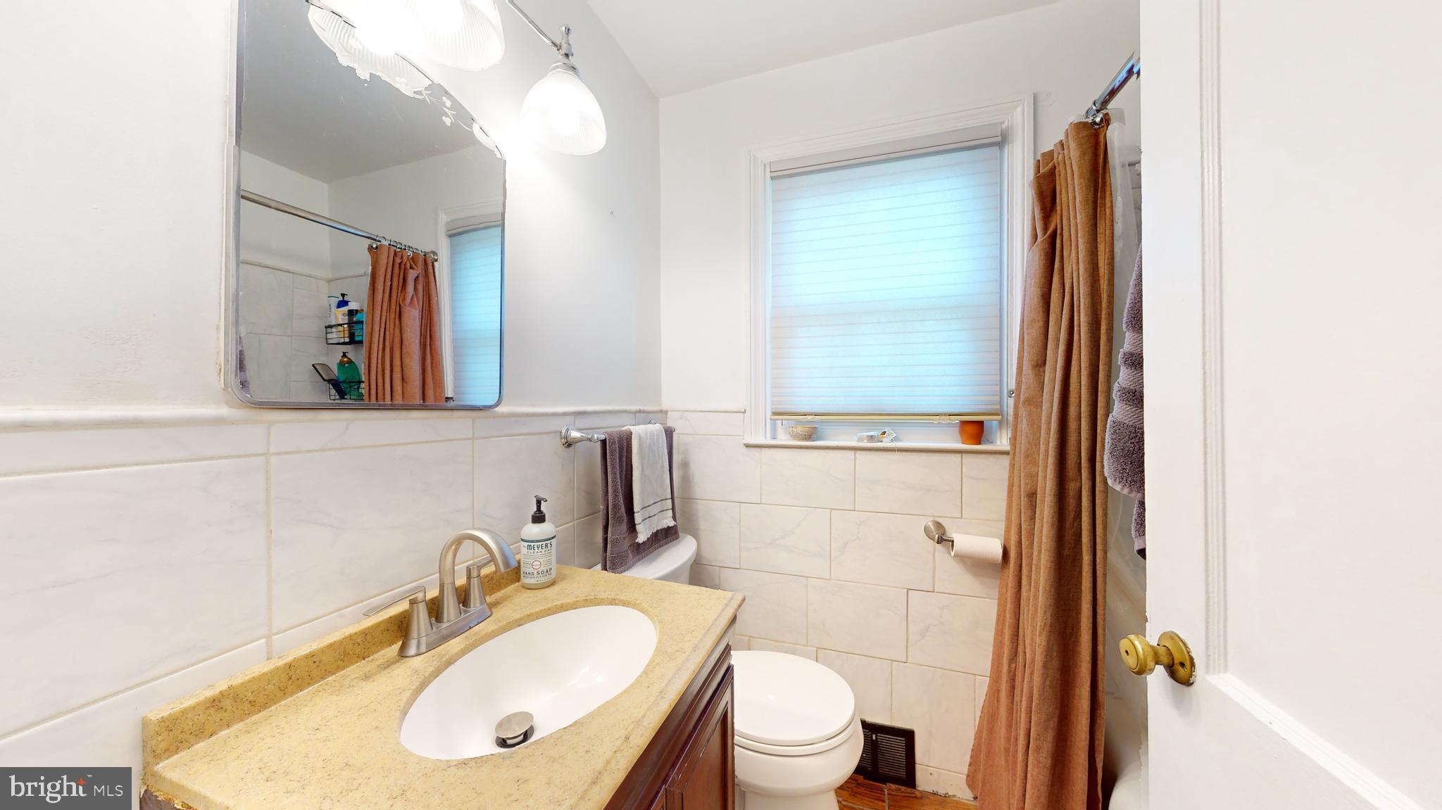 769 Ardmore Avenue Ardmore, PA 19003 - Photo 23 of 40 a bathroom with a sink toilet and mirror