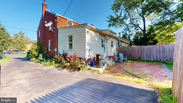 a view of a chairs and table in the back yard of the house