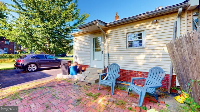 a view of a backyard with table and chairs and potted plants