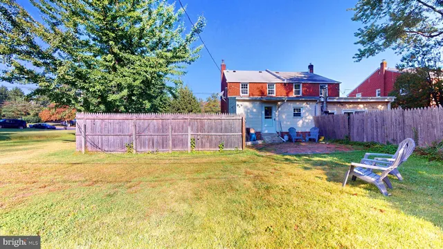 a yellow house in middle of the garden