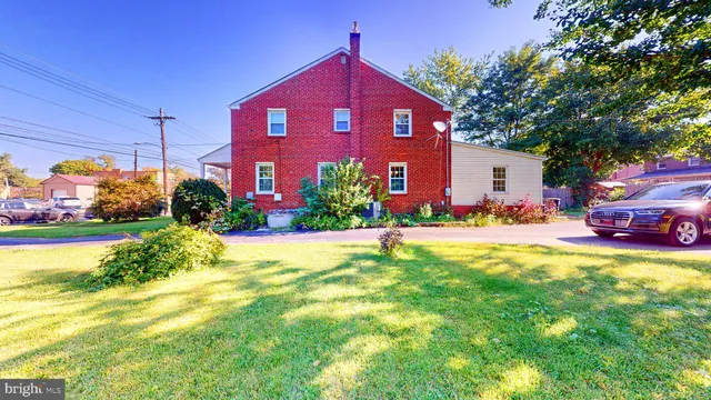 a view of a building with a yard and potted plants