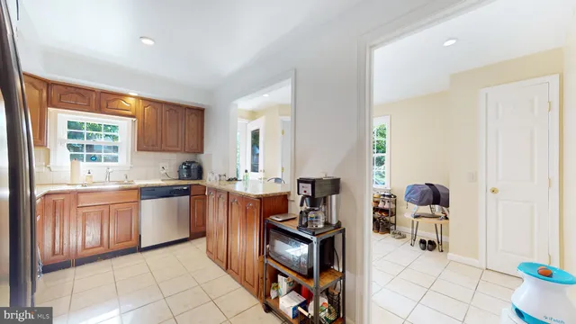 a kitchen with stainless steel appliances granite countertop a sink and cabinets