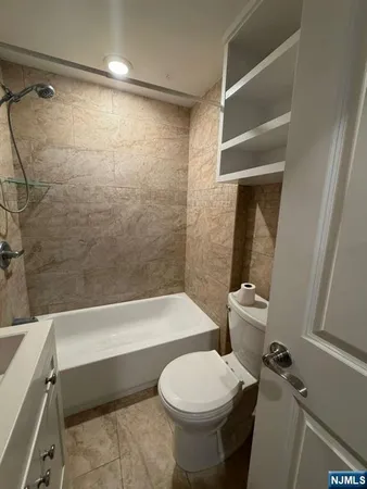 a bathroom with a toilet and a bathtub