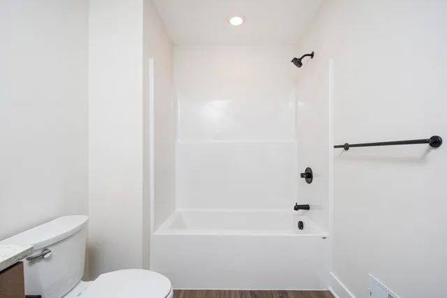 a bathroom with a bathtub and a toilet