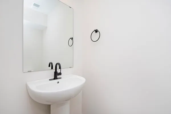 a bathroom with a sink and mirror