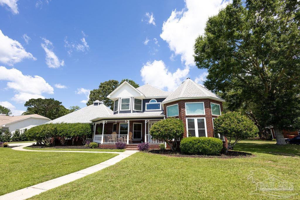 3059 Cobblestone Drive Pace, FL 32571 - Photo 1 of 45 a front view of a house with a yard