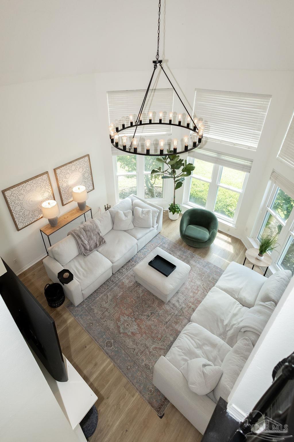 3059 Cobblestone Drive Pace, FL 32571 - Photo 11 of 45 a living room with furniture and a chandelier