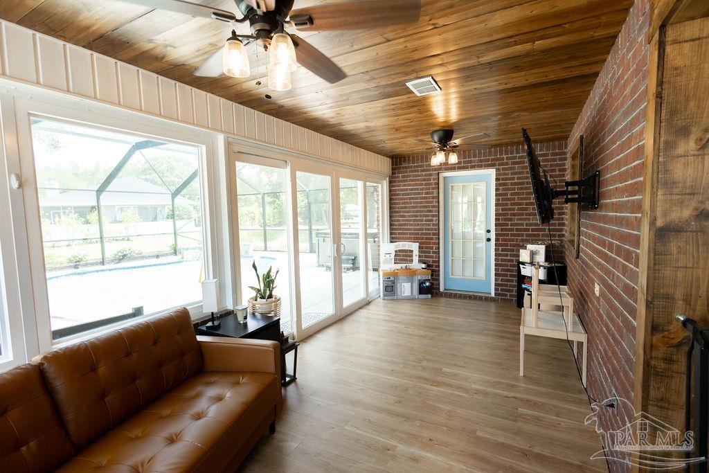 3059 Cobblestone Drive Pace, FL 32571 - Photo 14 of 45 a living room with furniture and a chandelier