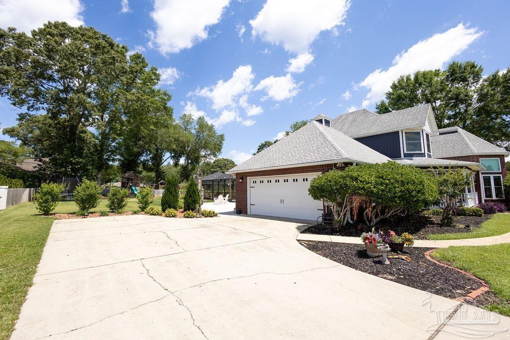 3059 Cobblestone Drive Pace, FL 32571 - Photo 17 of 45 a house view with a garden space