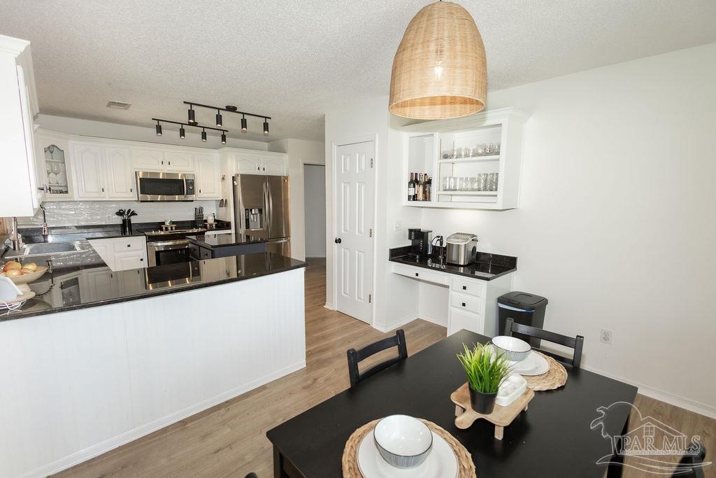 3059 Cobblestone Drive Pace, FL 32571 - Photo 19 of 45 a living room with furniture a flat screen tv and kitchen view