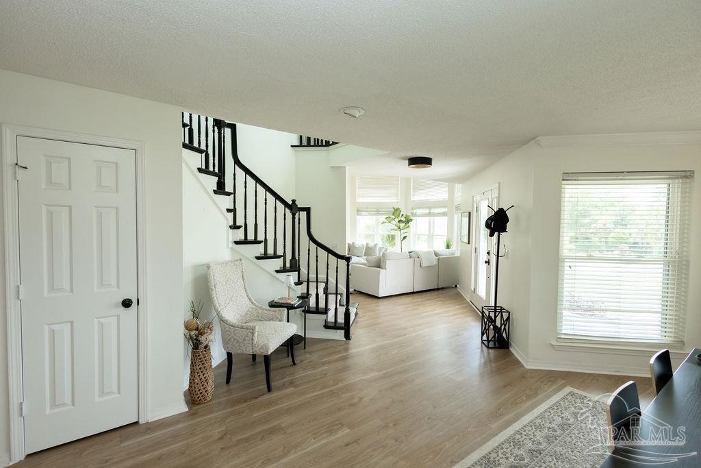3059 Cobblestone Drive Pace, FL 32571 - Photo 20 of 45 a living room with furniture and a wooden floor