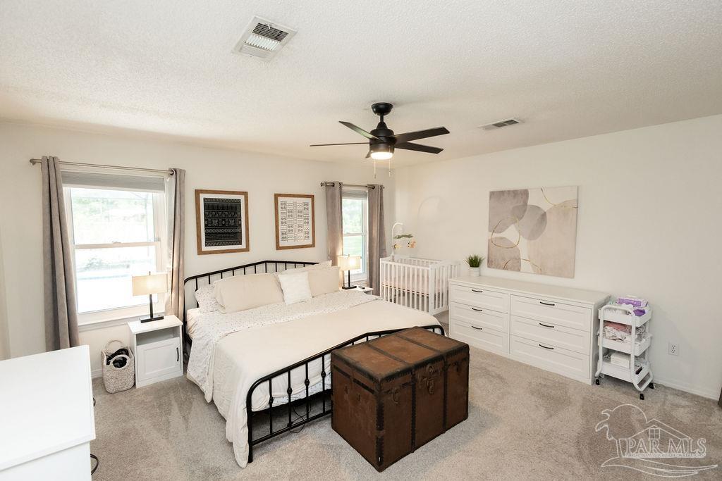 3059 Cobblestone Drive Pace, FL 32571 - Photo 24 of 45 a bed room with a bed and a window