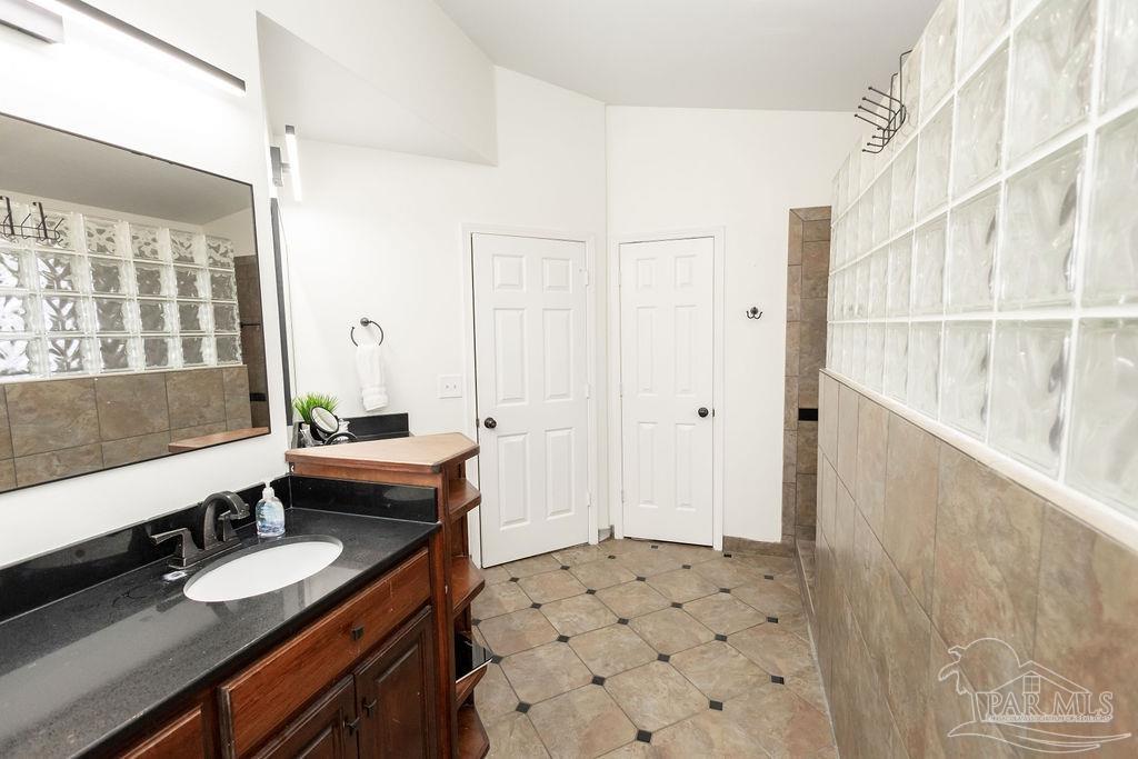 3059 Cobblestone Drive Pace, FL 32571 - Photo 25 of 45 a bathroom with a sink a toilet and shower