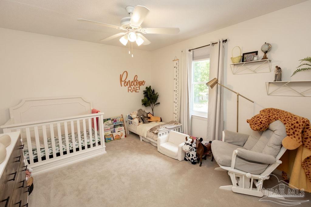3059 Cobblestone Drive Pace, FL 32571 - Photo 32 of 45 a living room with furniture and a chandelier