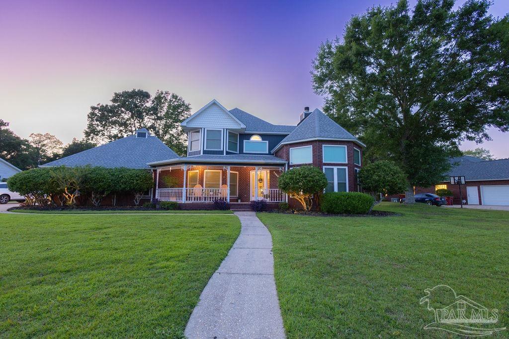 3059 Cobblestone Drive Pace, FL 32571 - Photo 38 of 45 a front view of a house with garden