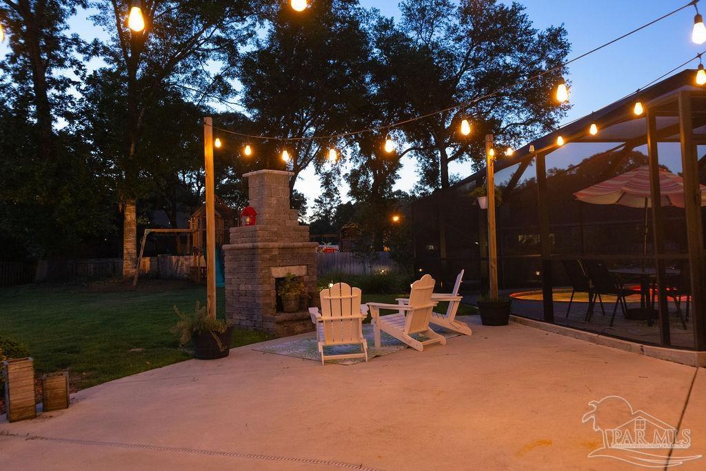 3059 Cobblestone Drive Pace, FL 32571 - Photo 40 of 45 a view of a patio with a table chairs and a fire pit