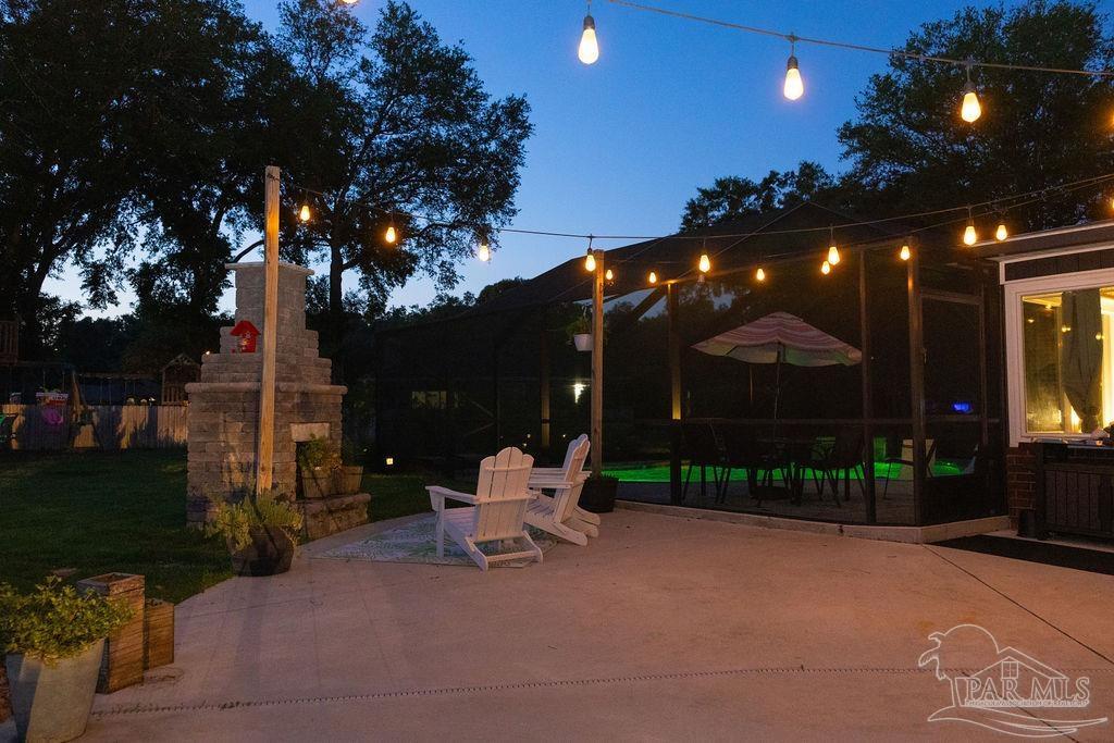 3059 Cobblestone Drive Pace, FL 32571 - Photo 42 of 45 a view of a patio with a table and chairs and potted plants