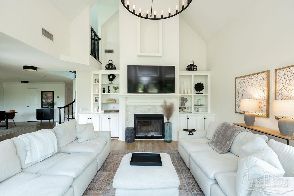 3059 Cobblestone Drive Pace, FL 32571 - Photo 5 of 45 a living room with furniture a fireplace and a flat screen tv