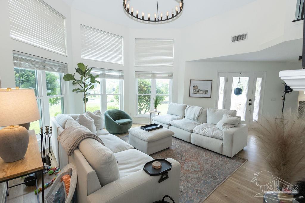 3059 Cobblestone Drive Pace, FL 32571 - Photo 6 of 45 a living room with furniture potted plant and a large window