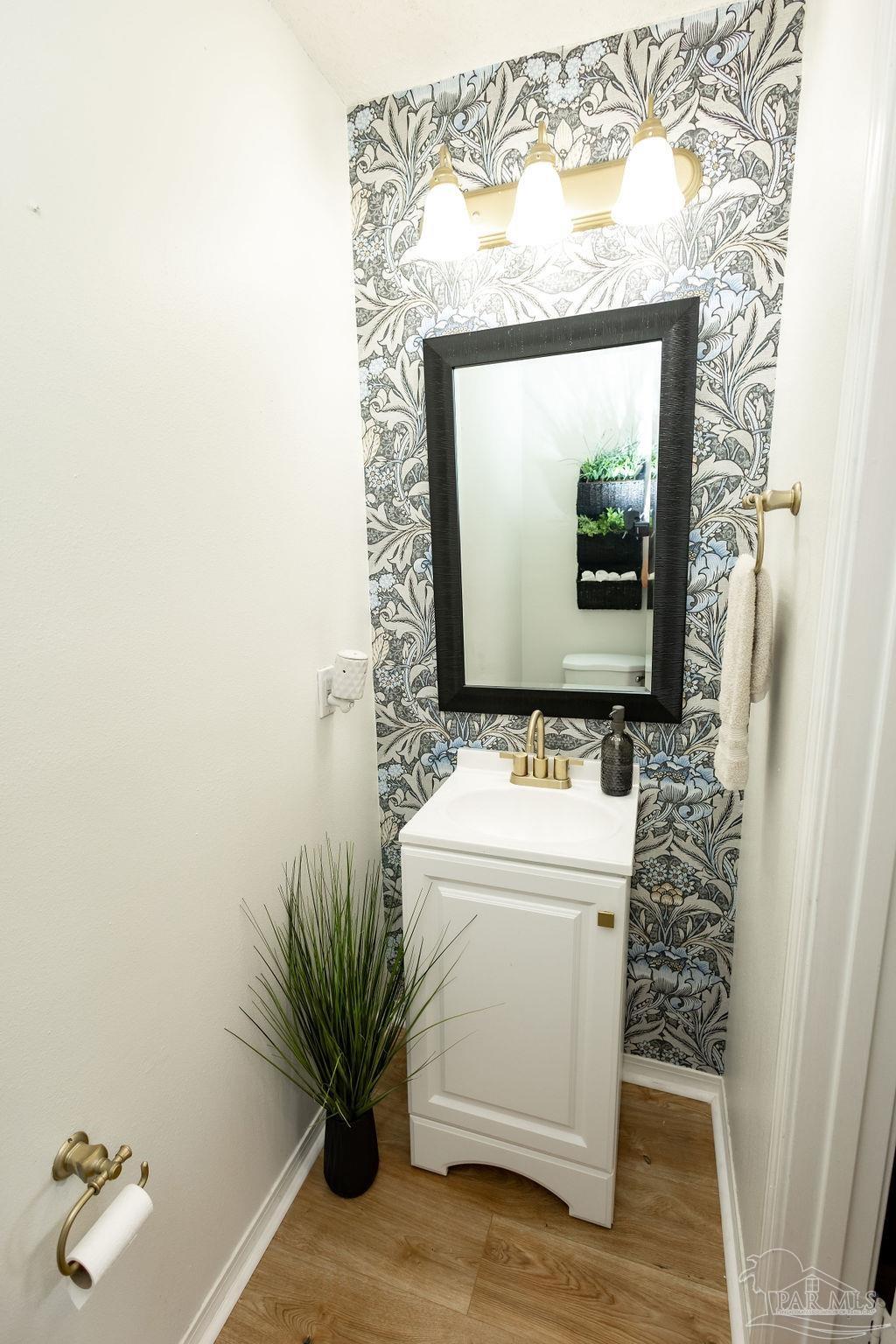 3059 Cobblestone Drive Pace, FL 32571 - Photo 7 of 45 a bathroom with a toilet sink and mirror