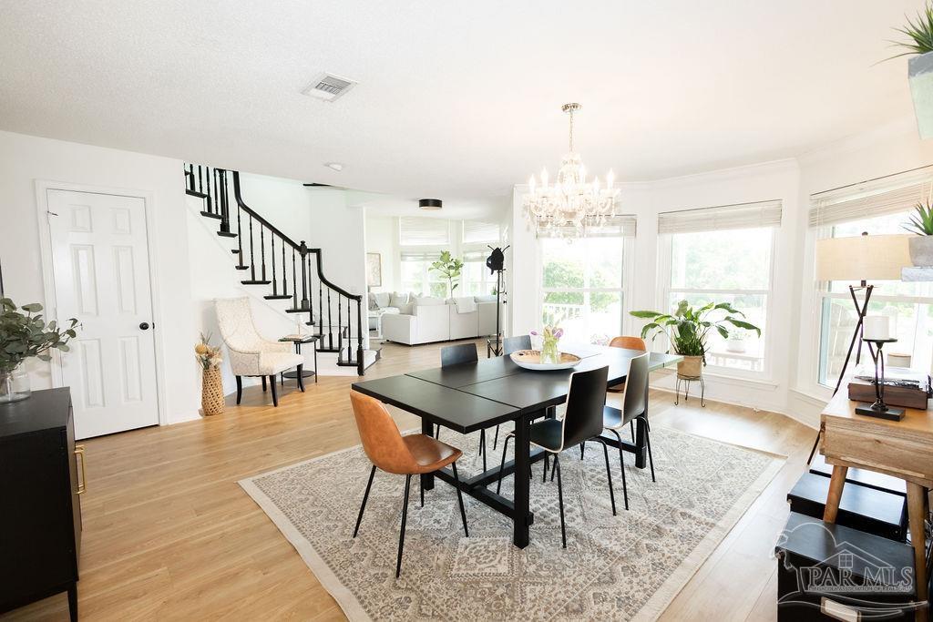 3059 Cobblestone Drive Pace, FL 32571 - Photo 8 of 45 a view of a a dining room with furniture window and wooden floor