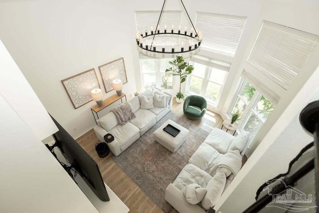 3059 Cobblestone Drive Pace, FL 32571 - Photo 9 of 45 a living room with furniture and a chandelier