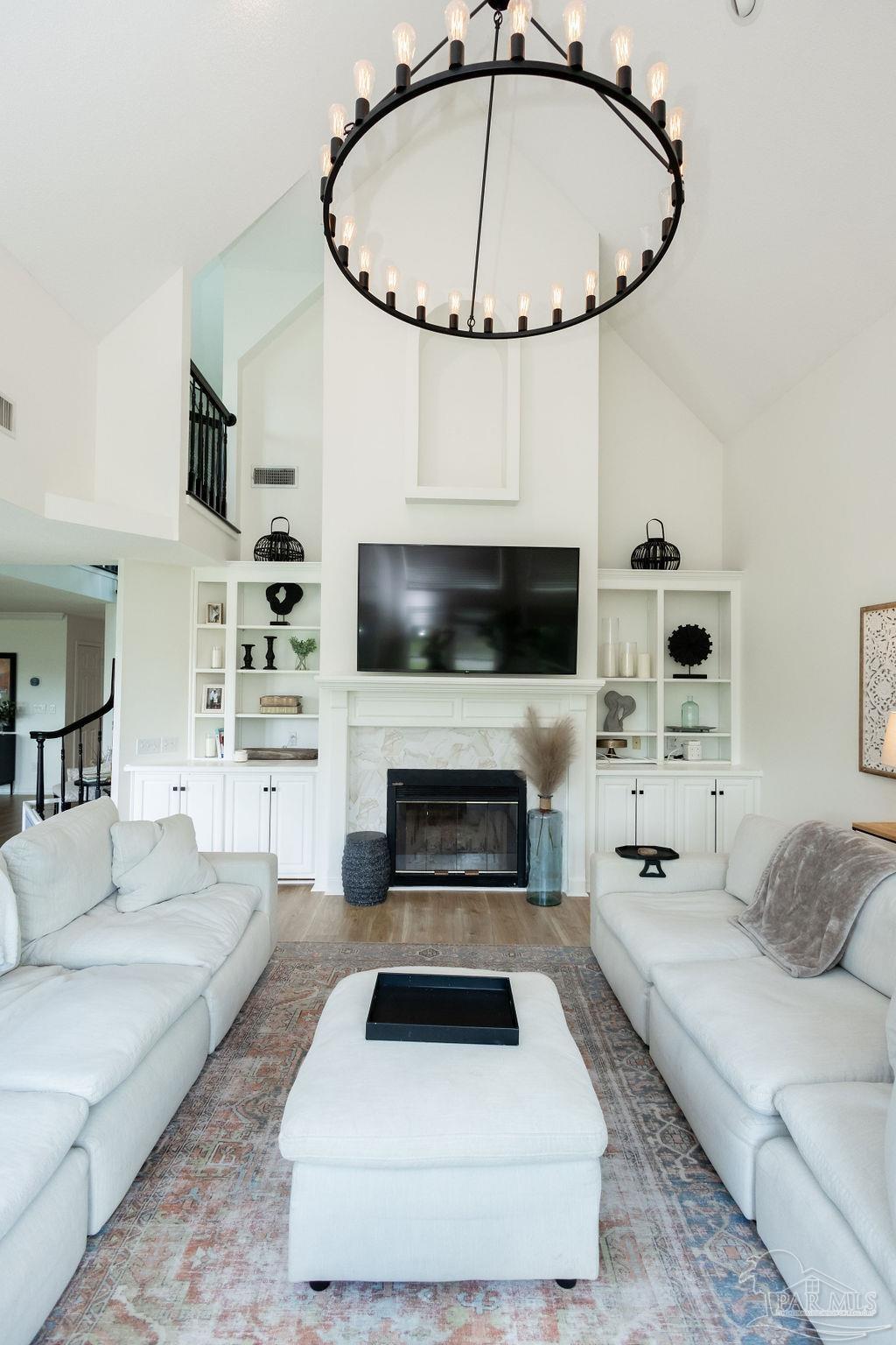 3059 Cobblestone Drive Pace, FL 32571 - Photo 10 of 45 a living room with furniture a flat screen tv and a fireplace