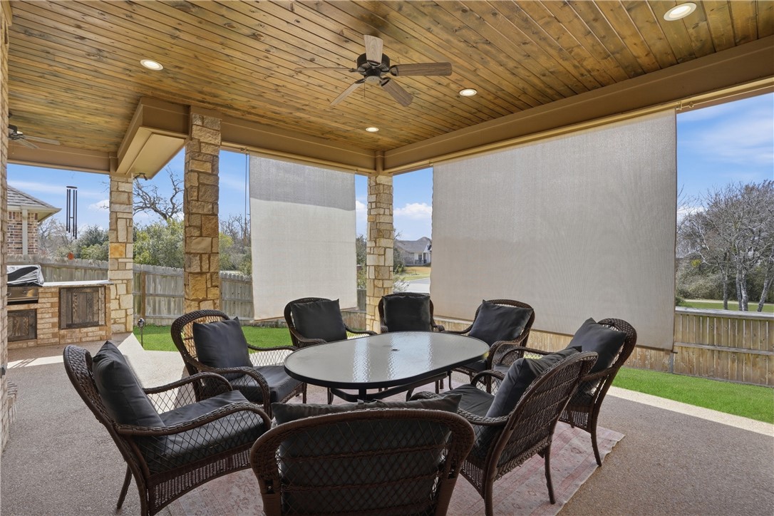 3516 Foxcroft Path Bryan, TX 77808 - Photo 30 of 38 a dining room with furniture and a floor to ceiling window