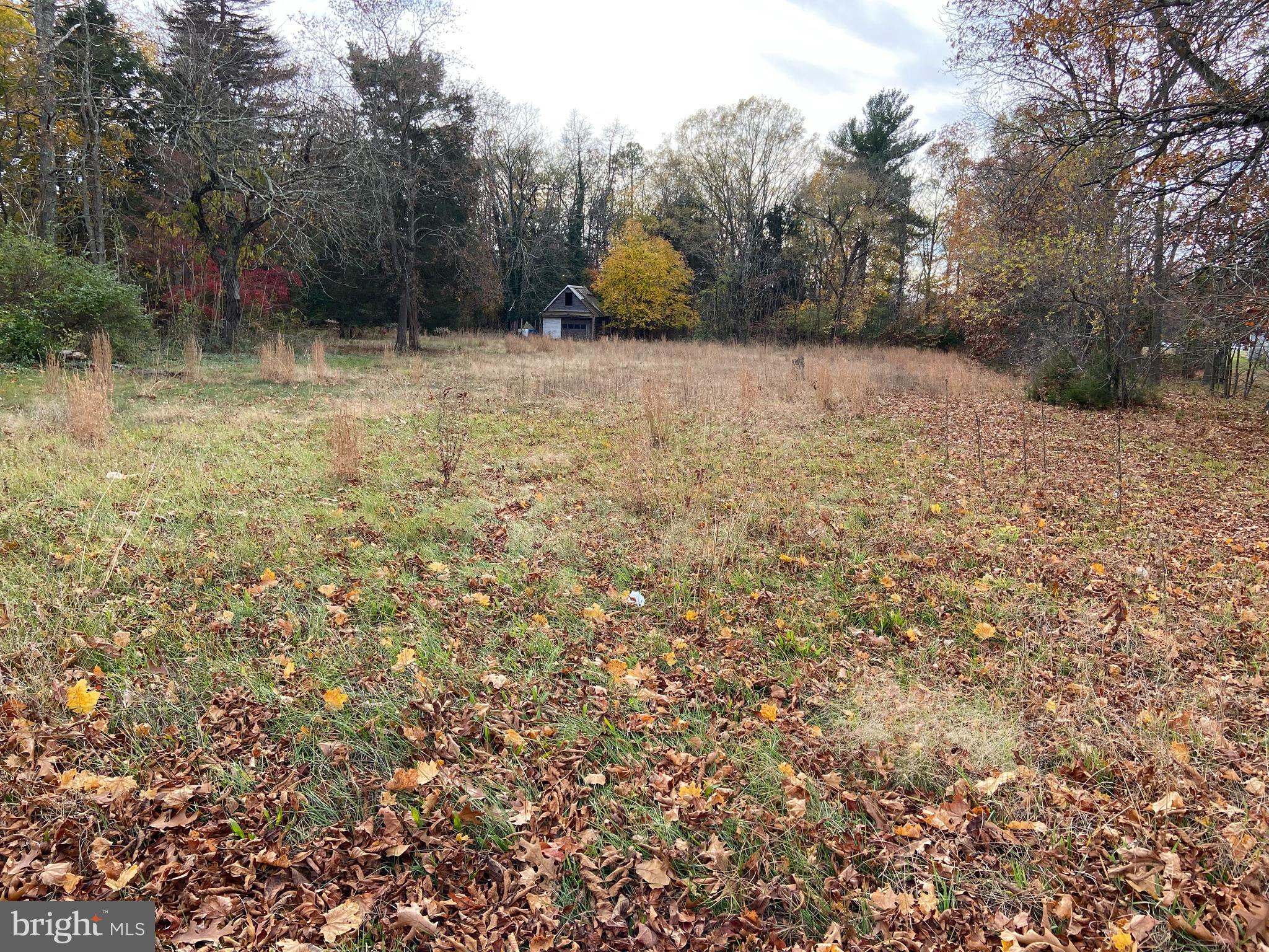 26 Magnolia Road Pemberton, NJ 08068 - Photo 2 of 3 a backyard of a house with trees and outdoor space