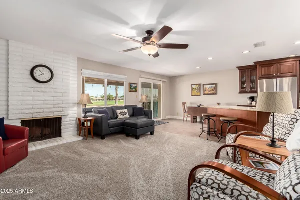 a living room with furniture fireplace and window
