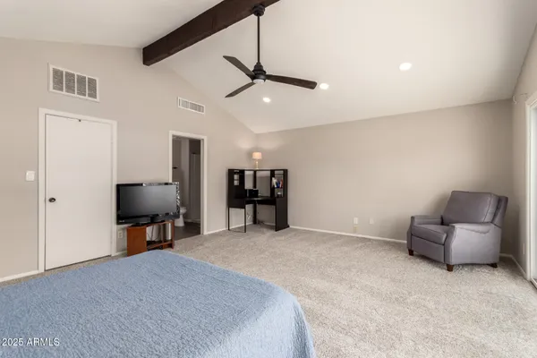 a bedroom with a bed and flat screen tv