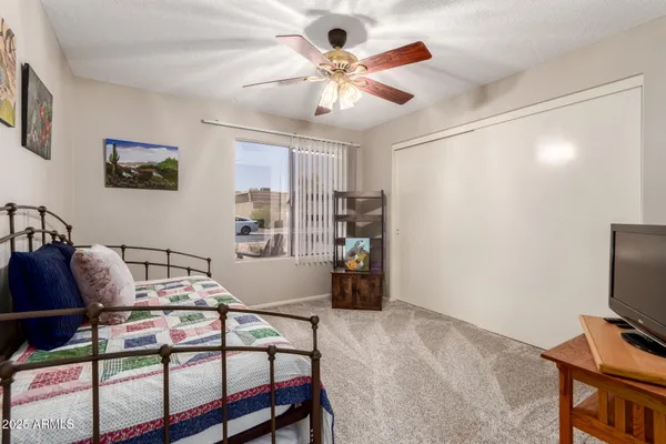 a large bedroom with furniture and window