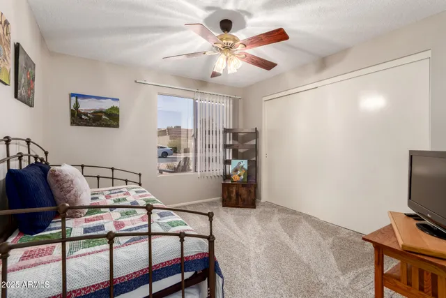 a large bedroom with furniture and window