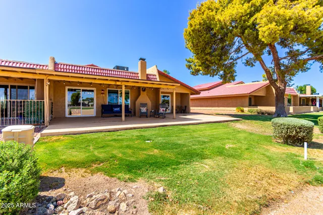 an aerial view of a residential houses with outdoor space and swimming pool