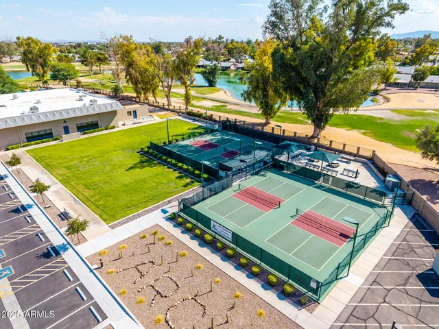a view of a lake with tables and chairs