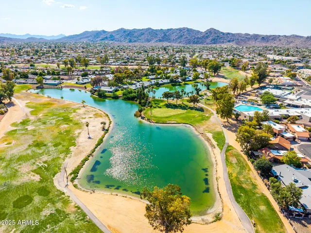 a living room with lots of furniture and a book shelf