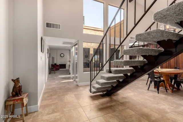 a view of a hallway with seating area and entryway