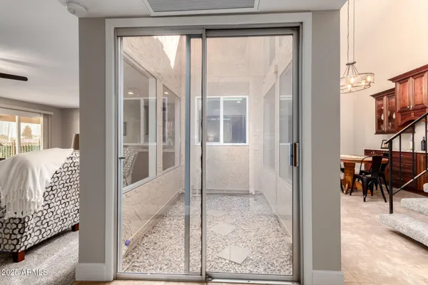 a bedroom with furniture and a flat screen tv