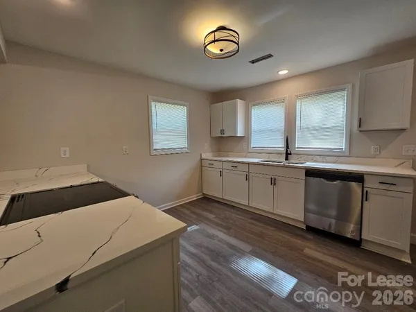 a kitchen with a sink cabinets and window