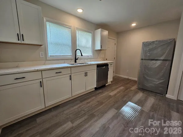 a kitchen with sink and cabinets