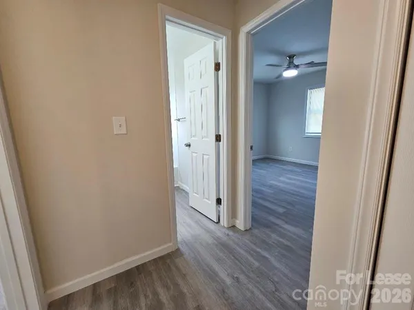 a view of a hallway with wooden floor