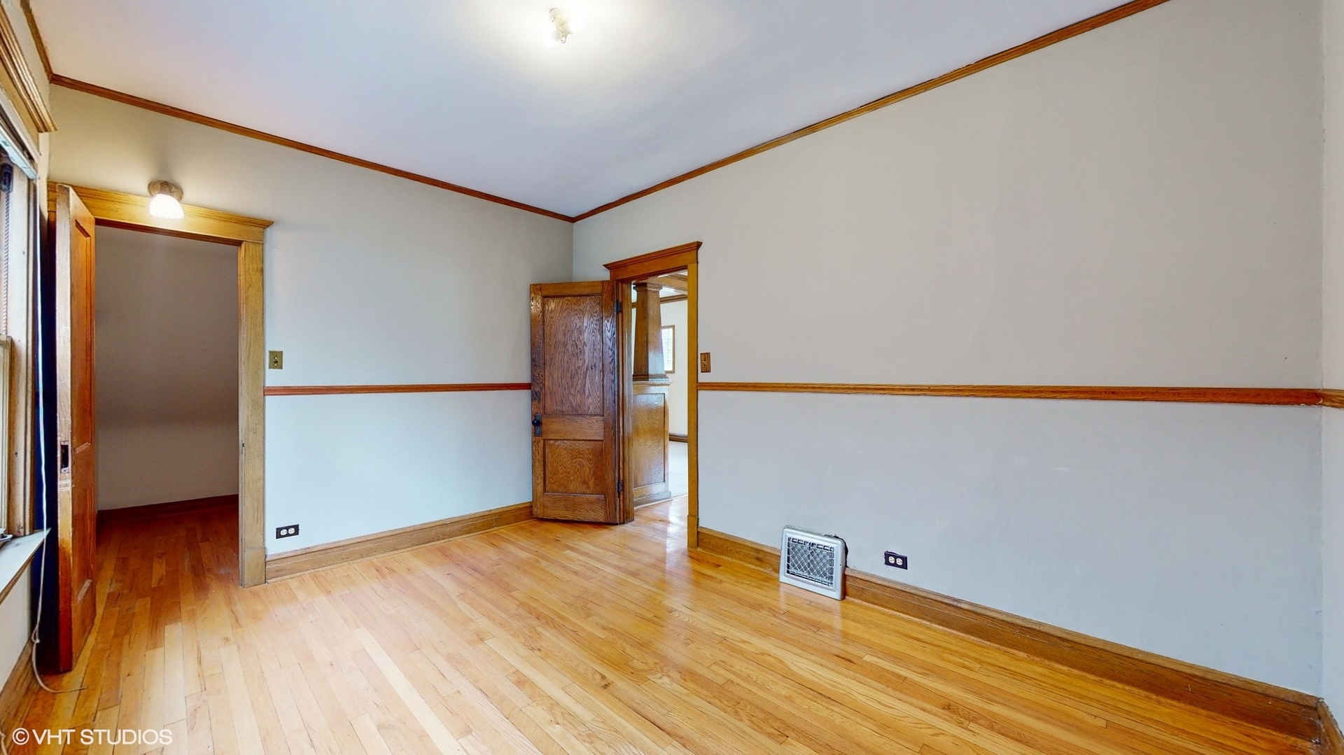 1035 South Ridgeland Avenue Oak Park, IL 60304 - Photo 14 of 43 a view of an empty room with wooden floor and a window
