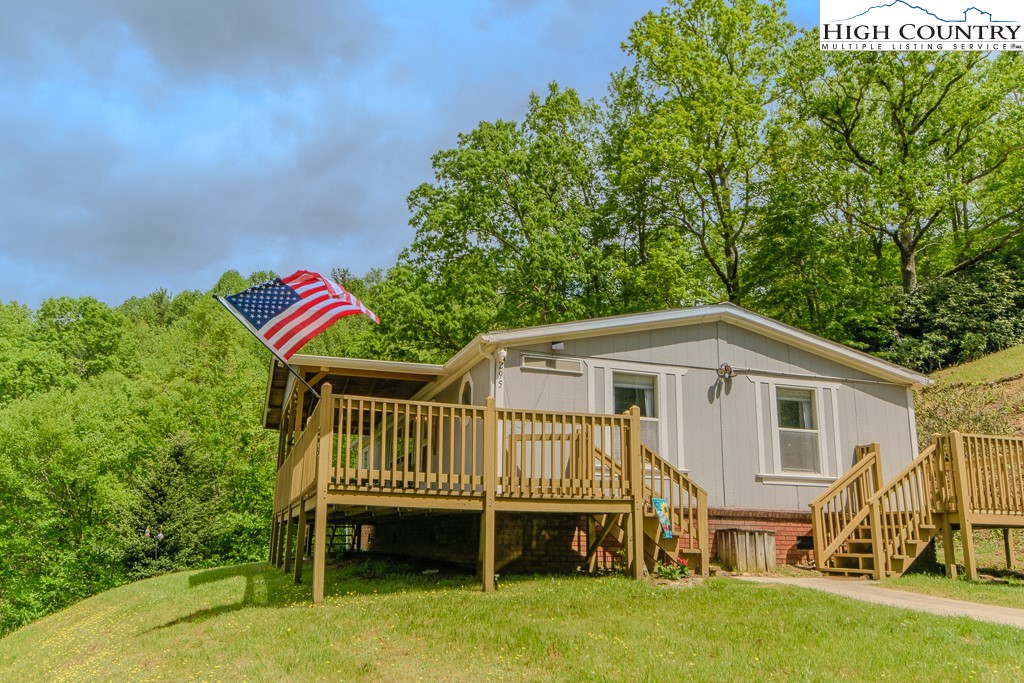 295 Roy E Brown Road Vilas, NC 28692 - Photo 1 of 43 a view of a house with a yard and furniture
